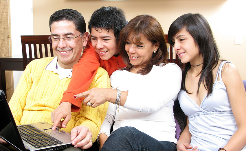 Family looking at laptop